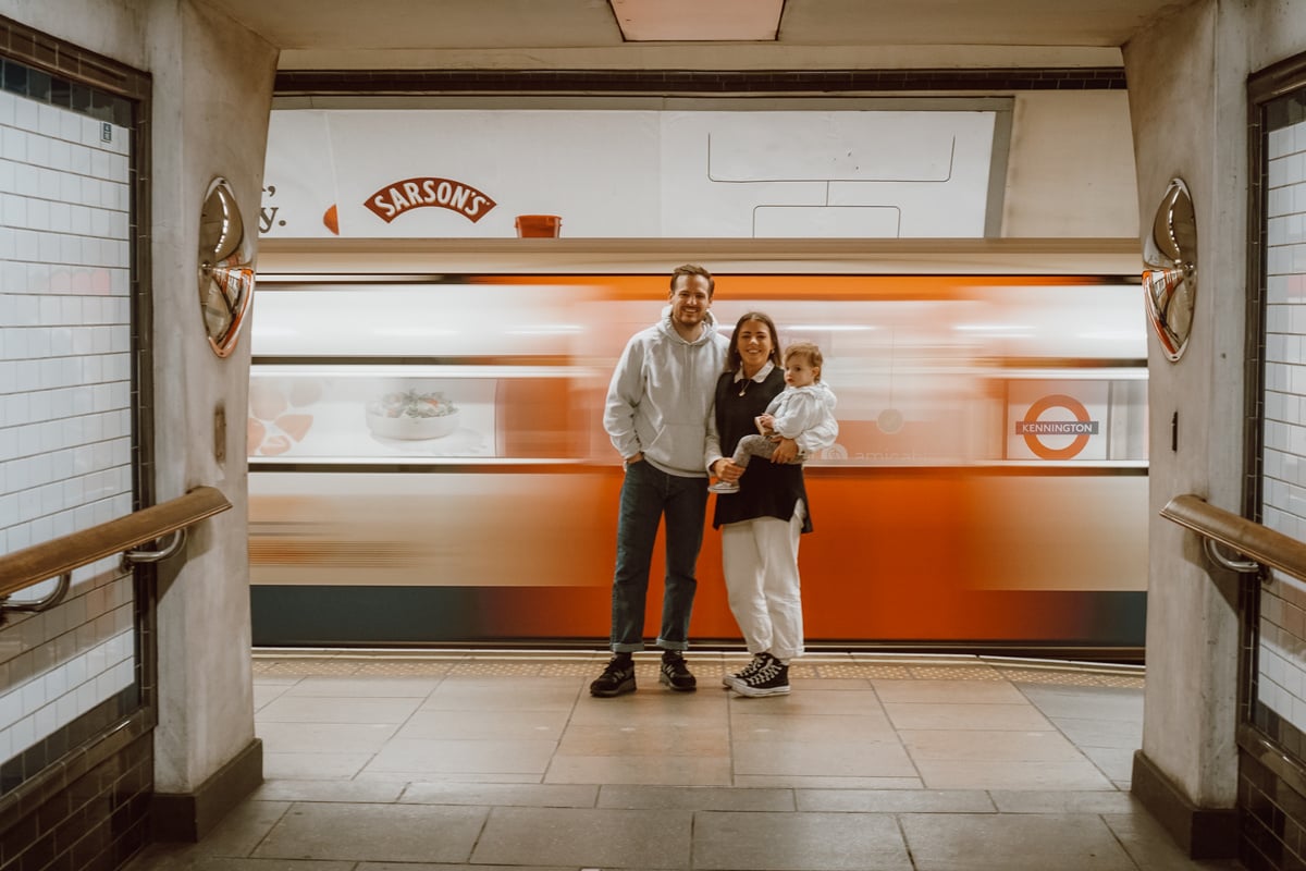 a family portrait in front of a moving London Underground tube