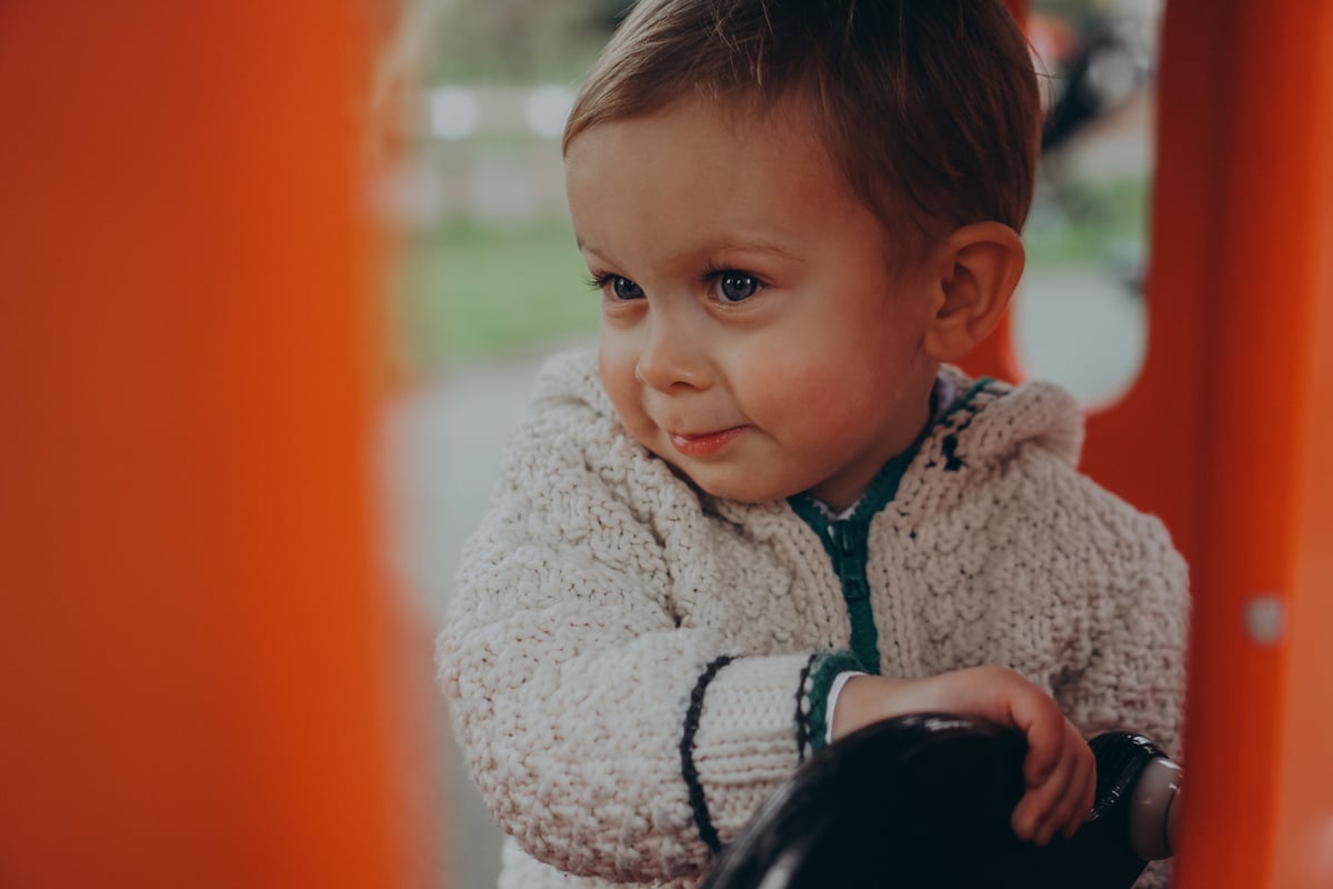 a little boy playing on a train
