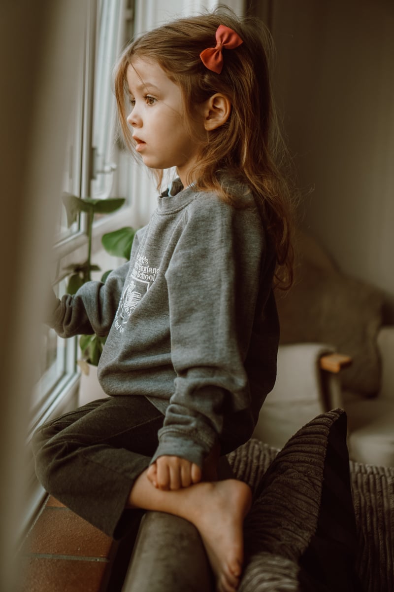 a little child looking out the window